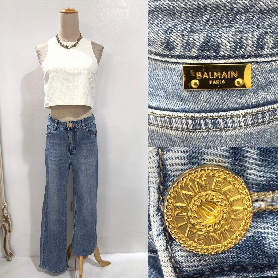 Balmain Paris Denim Jeans (Category: Jeans) located in Bacolod City. Submitted by bhabissagal-05763 (Listing ID 1468141694, Image 1). Description: - Brand: Balmain Paris - Color/Wash: Medium blue, clean solid wash - Fit: Straight wide leg - Details: Gold metal button closure with embossed branding and matching gold rear logo plaque - Pockets: Classic back pockets - Condition/Style: Versatile everyday luxury denim.