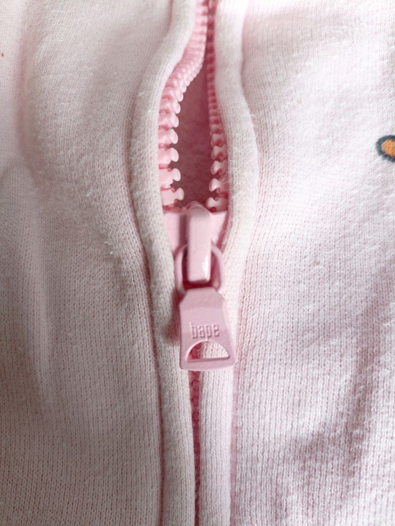 BAPE kidz Milo Monogram (Category: Babies & Kids Fashion) located in Manila. Submitted by ogiefernandez (Listing ID 1468083957, Image 3). Description: - 100% Authentic BAPE Kids pink full-zip hoodie - Iconic all-over Baby Milo graphic print - Classic shark face hood with contrast teeth, eyes, and tiger stripe back detail - Branded pink zipper hardware with woven neck and gold sleeve tags - Cozy soft fleece lining and convenient front zip pockets.
