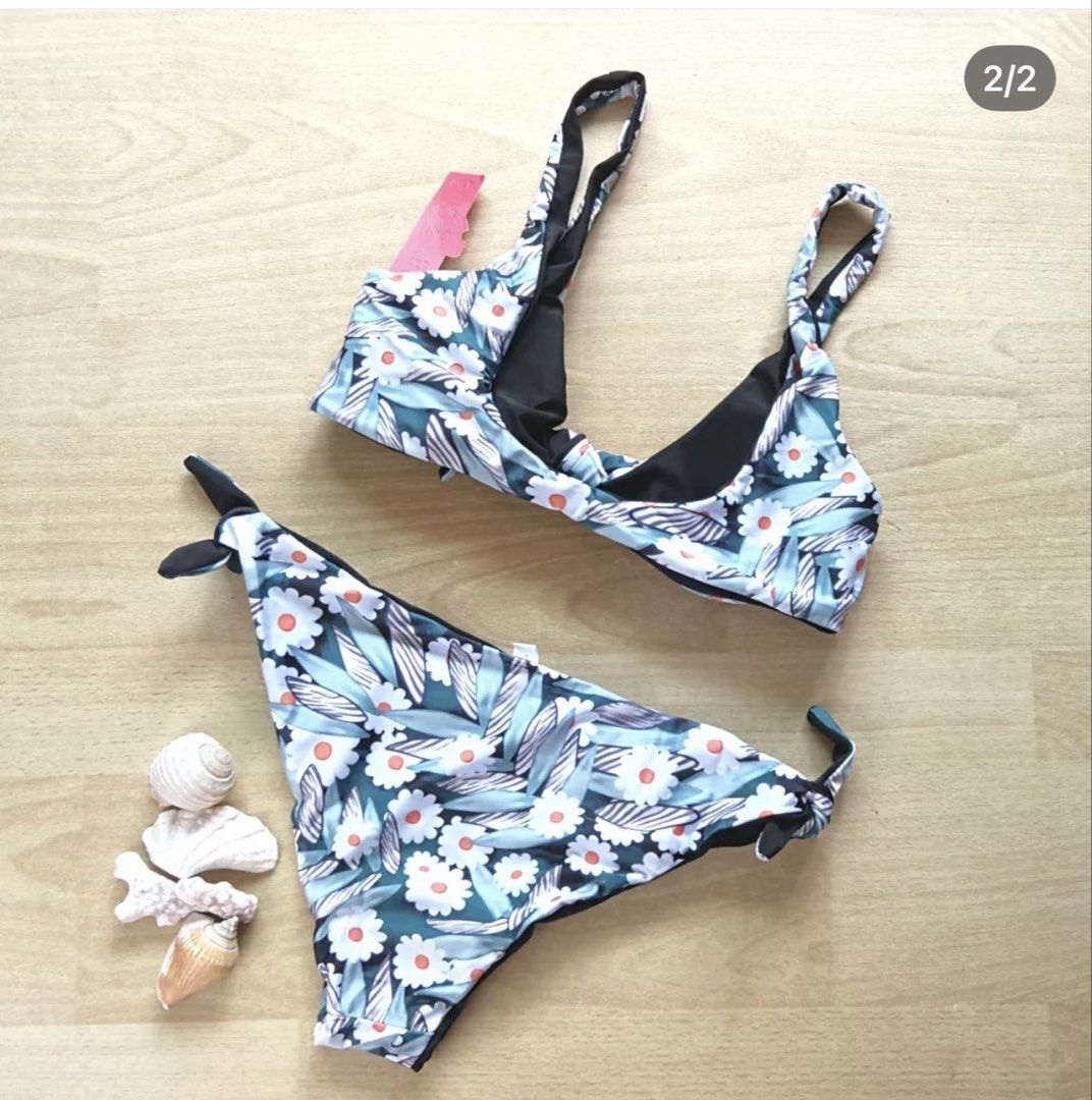 BEA & COS Floral Bikini Set Size L (Category: Bikinis & Swimsuits) located in Bulacan. Submitted by peach1025 (Listing ID 1468101429, Image 2). Description: - Brand: BEA & COS - Condition: Brand new with original red store tag attached - Size: L - Design: Reversible blue floral print with solid black lining - Top: Chic twisted knot detail - Bottoms: Adjustable side-tie style.