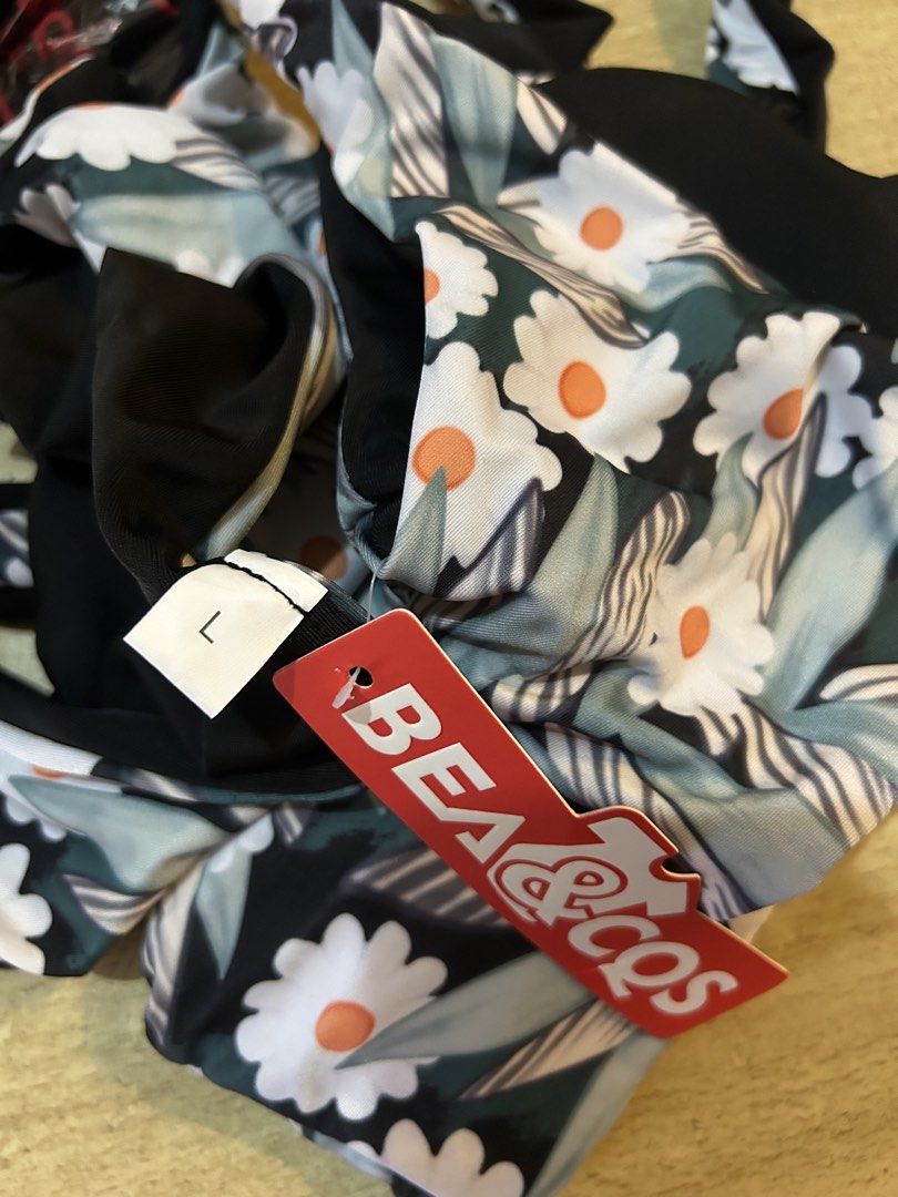 BEA & COS Floral Bikini Set Size L (Category: Bikinis & Swimsuits) located in Bulacan. Submitted by peach1025 (Listing ID 1468101429, Image 3). Description: - Brand: BEA & COS - Condition: Brand new with original red store tag attached - Size: L - Design: Reversible blue floral print with solid black lining - Top: Chic twisted knot detail - Bottoms: Adjustable side-tie style.