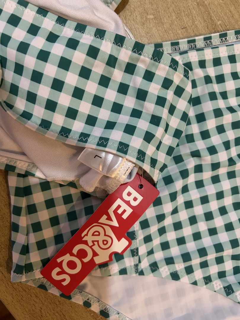 Beach & Cos Green Gingham High Waist Bikini Set (Category: Bikinis & Swimsuits) located in Bulacan. Submitted by peach1025 (Listing ID 1468104404, Image 3). Description: - Brand: Beach & Cos - Style: Green and white gingham bikini set with tie-front crop top and high-waisted bottoms - Size: L (tag attached) - Condition: Brand new, unworn with original red brand hang tag still on.
