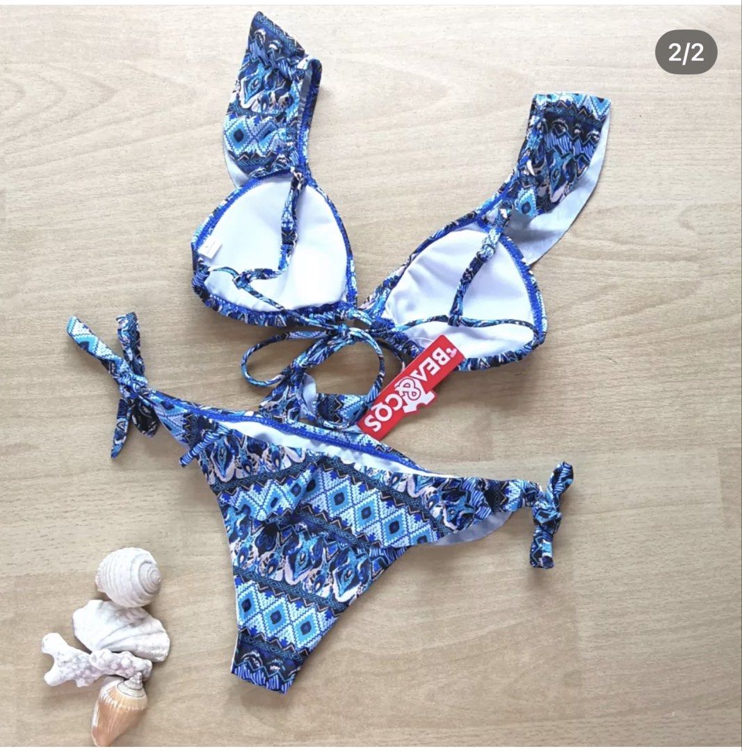 BEA&COS Blue Pattern Ruffle Bikini Set Size L (Category: Bikinis & Swimsuits) located in Bulacan. Submitted by peach1025 (Listing ID 1468105913, Image 2). Description: - Brand: BEA&COS - Condition: Brand new with tags (BNWT) - Size: L - Color/Design: Blue and white patterned - Details: Ruffle shoulder straps on top, adjustable side ties on bottoms.