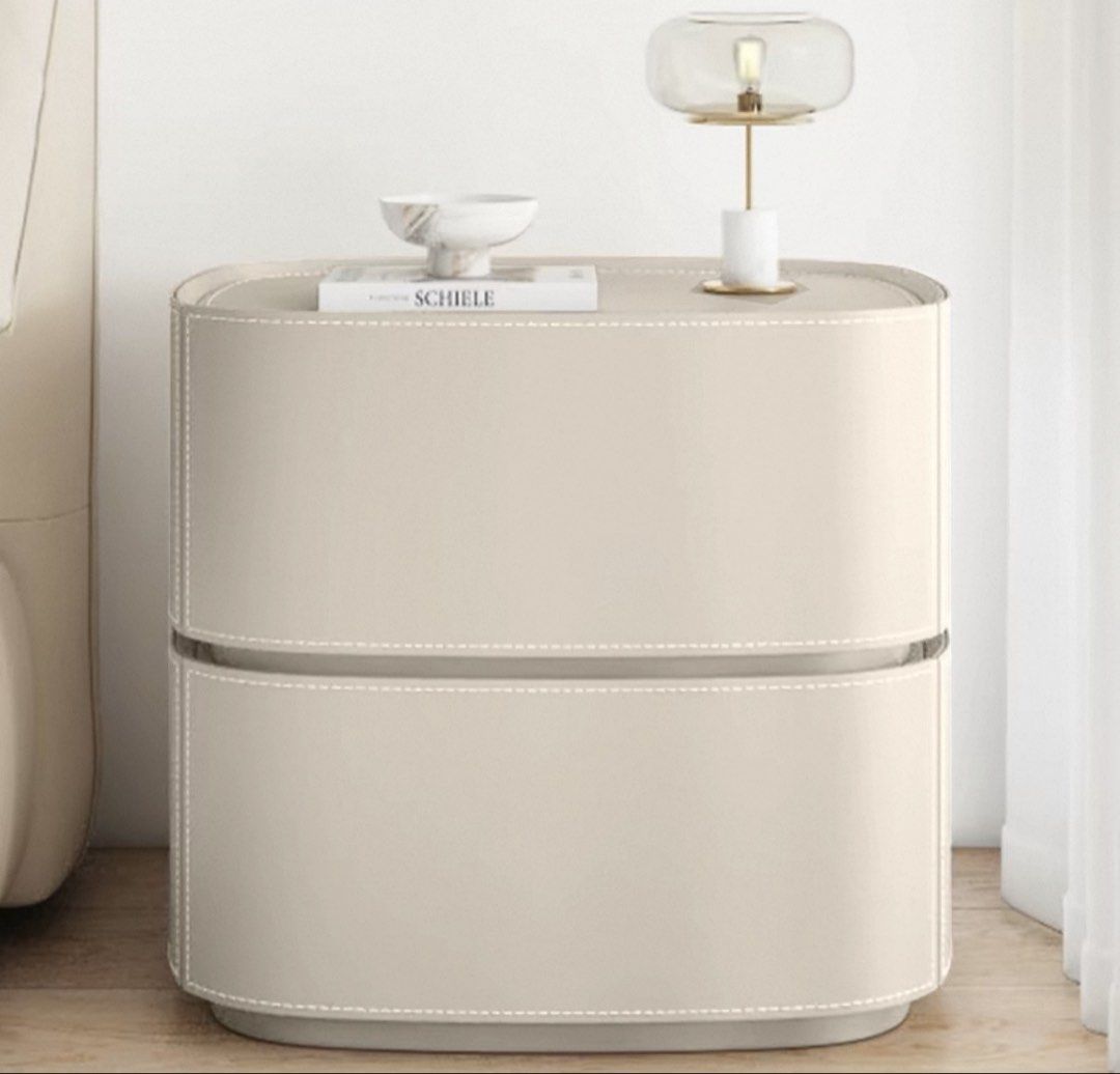 Bedside table (Category: Tables & Sets) located in Singapore. Submitted by redcrumble (Listing ID 1468062315, Image 2). Description: Off white colour Top compartment comes with non functional fingerprint lock Soft closure drawers Leather interior and exterior 50x40x50cm .