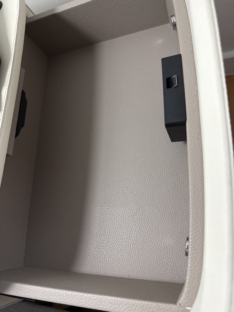 Bedside table (Category: Tables & Sets) located in Singapore. Submitted by redcrumble (Listing ID 1468062315, Image 3). Description: Off white colour Top compartment comes with non functional fingerprint lock Soft closure drawers Leather interior and exterior 50x40x50cm .