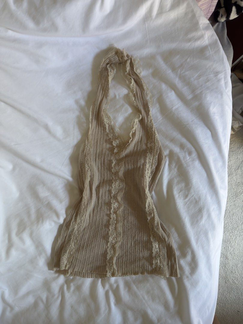 Beige Lace Trim Halter Top (Category: Sleeveless) located in Quezon City. Submitted by ianabanana20 (Listing ID 1468123450, Image 1). Description: - Style: Y2K fairy grunge - Color: Beige - Design: V-neck halter with delicate lace trim - Material: Soft, ribbed fabric with great stretch - Fit: Small to medium - Condition: Great.