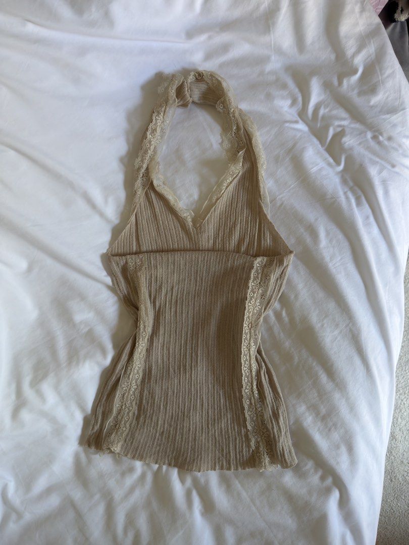 Beige Lace Trim Halter Top (Category: Sleeveless) located in Quezon City. Submitted by ianabanana20 (Listing ID 1468123450, Image 2). Description: - Style: Y2K fairy grunge - Color: Beige - Design: V-neck halter with delicate lace trim - Material: Soft, ribbed fabric with great stretch - Fit: Small to medium - Condition: Great.