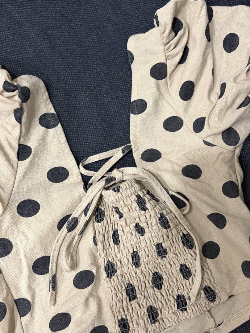 Beige Polka Dot Crop Top with Puff Sleeves (Category: Blouses) located in Manila. Submitted by cpaa.aaa (Listing ID 1468136338, Image 3). Description: Beige with black polka dots Size: XS-M Square neckline puff sleeves Adjustable tie-back detail Stretchy smocked back panel for comfort, cropped length .