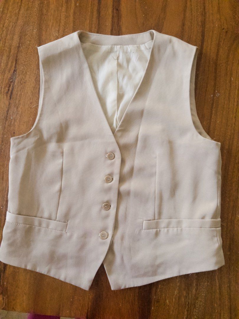 Beige tailored vest (Category: Sleeveless) located in Angeles City. Submitted by msr093 (Listing ID 1468113037, Image 2). Description: - Color: Beige - Style: Tailored waistcoat with clean lines - Closure: Four front buttons - Lining: Fully lined with white fabric .