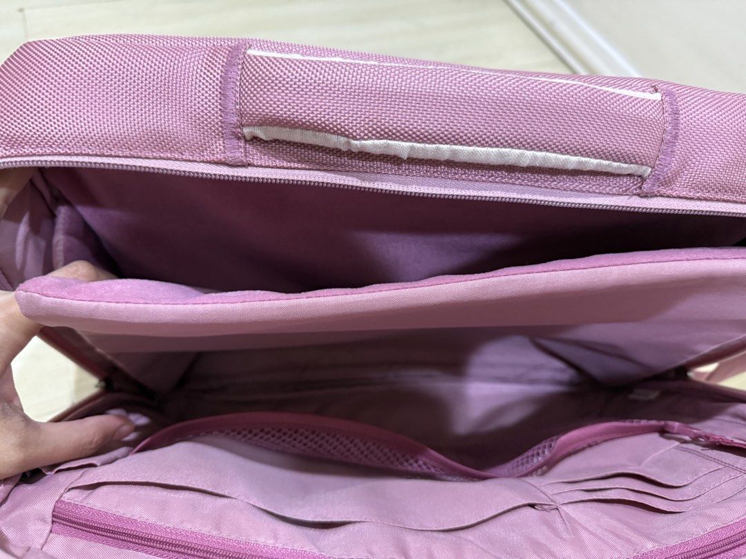 Belkin Laptop bag blush (Category: Shoulder Bags) located in Taguig. Submitted by preloved.by.diane (Listing ID 1468243465, Image 3). Description: - Color: Dusty pink - Material: Durable textured nylon - Strap: Adjustable with buckle - Laptop/Tablet: Padded divider in main compartment - Storage: Mesh zip pocket, open slip pockets, and card slots - Condition: Brand new / Excellent quality.