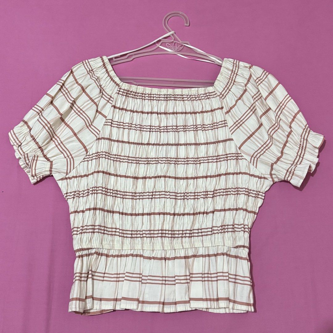 Bershka Plaid Smocked Top (Category: Blouses) located in San Fernando. Submitted by declotter (Listing ID 1468081569, Image 2). Description: - Brand: Bershka - Color: White with brown plaid stripes - Design: V-neckline with ruffled cap sleeves and peplum hem - Fit: Stretchy body for a comfortable fit - Style: Versatile, easy to dress up with jeans or a skirt .