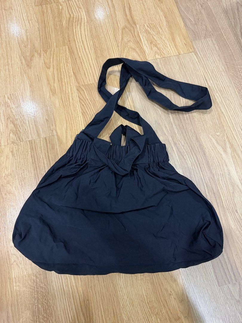 Beyond The Vines Black Dumpling Bag in Medium (Category: Shoulder Bags) located in Manila. Submitted by shopishka (Listing ID 1468219278, Image 2). Description: Beyond The Vines black shoulder bag. Lightweight nylon material, gathered elasticized opening. Front pocket with printed white logo lettering. Adjustable crossbody strap attached, plus dual top carry handles. Handy D-ring hardware on the front. Clean interior, gently carried a few times. 