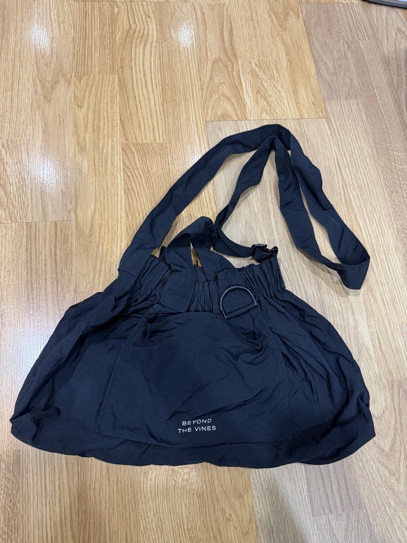 Beyond The Vines Black Dumpling Bag in Medium (Category: Shoulder Bags) located in Manila. Submitted by shopishka (Listing ID 1468219278, Image 1). Description: Beyond The Vines black shoulder bag. Lightweight nylon material, gathered elasticized opening. Front pocket with printed white logo lettering. Adjustable crossbody strap attached, plus dual top carry handles. Handy D-ring hardware on the front. Clean interior, gently carried a few times. 