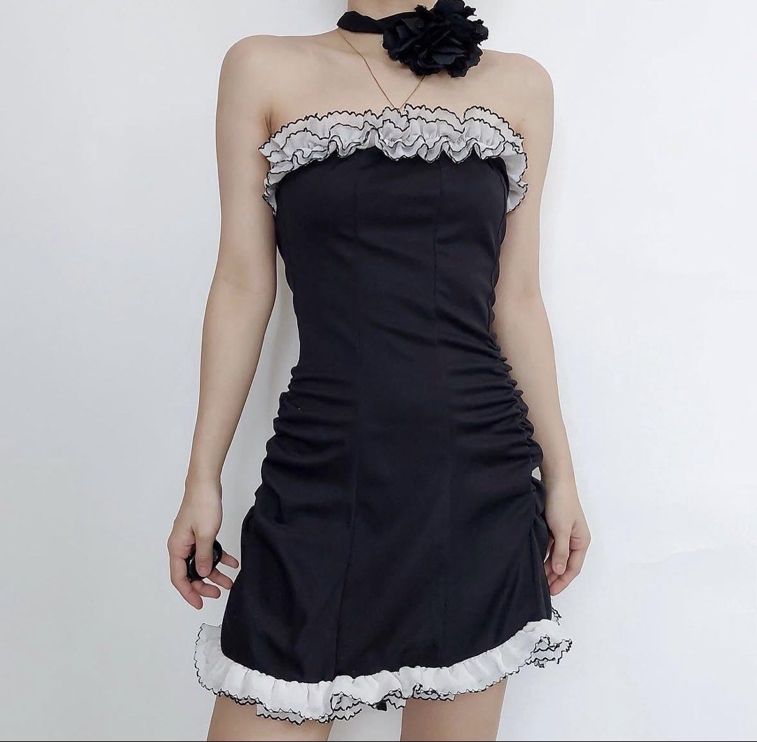 Black and White Ruffle Strapless Mini Dress (Category: Dresses) located in Manila. Submitted by chlstnz (Listing ID 1468212445, Image 1). Description: - Style: Black strapless mini dress with ruched sides for a flattering fit - Details: White ruffled trim along the neckline and hem with contrasting lettuce edge stitching - Fabric: Soft, stretchy, and easy to pull on - Occasion: Great for parties, dates, or casual outings - dm for more pics 💗.