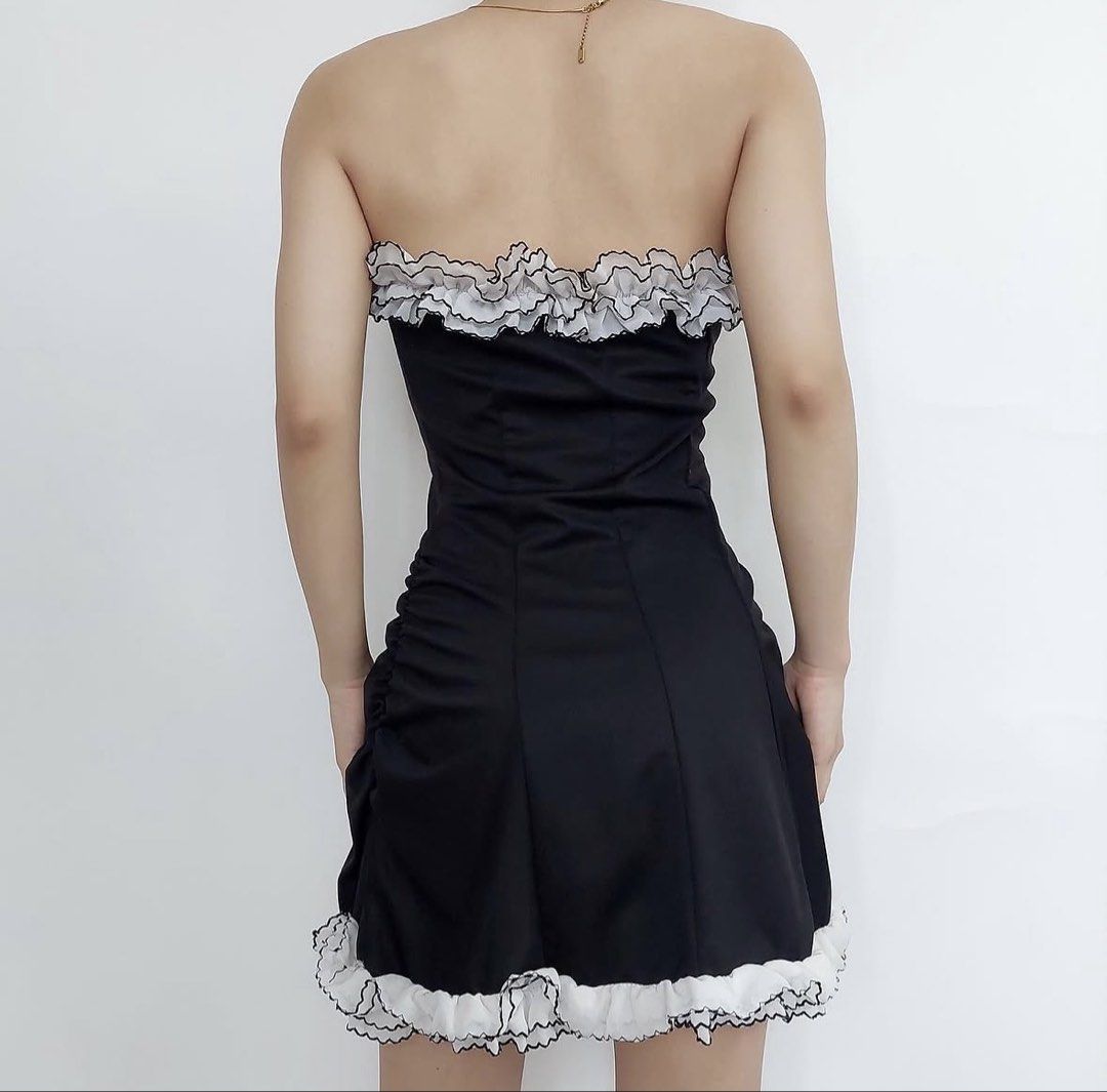 Black and White Ruffle Strapless Mini Dress (Category: Dresses) located in Manila. Submitted by chlstnz (Listing ID 1468212445, Image 2). Description: - Style: Black strapless mini dress with ruched sides for a flattering fit - Details: White ruffled trim along the neckline and hem with contrasting lettuce edge stitching - Fabric: Soft, stretchy, and easy to pull on - Occasion: Great for parties, dates, or casual outings - dm for more pics 💗.