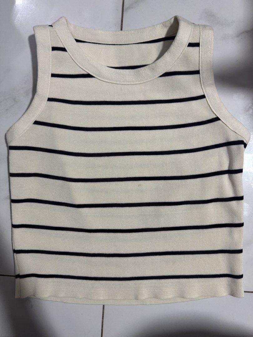Black and White Striped Ribbed Tank Top (Category: Sleeveless) located in Manila. Submitted by decluterthings888 (Listing ID 1468226673, Image 2). Description: - Color: Black and white stripes - Style: Classic scoop neckline, sleeveless - Fabric: Stretchy ribbed knit that hugs the body - Versatility: Great for layering or wearing on its own - Condition: Brand new / Excellent quality - Mode of Payment: GCash, BPI, or COD available - Shipping: Fast