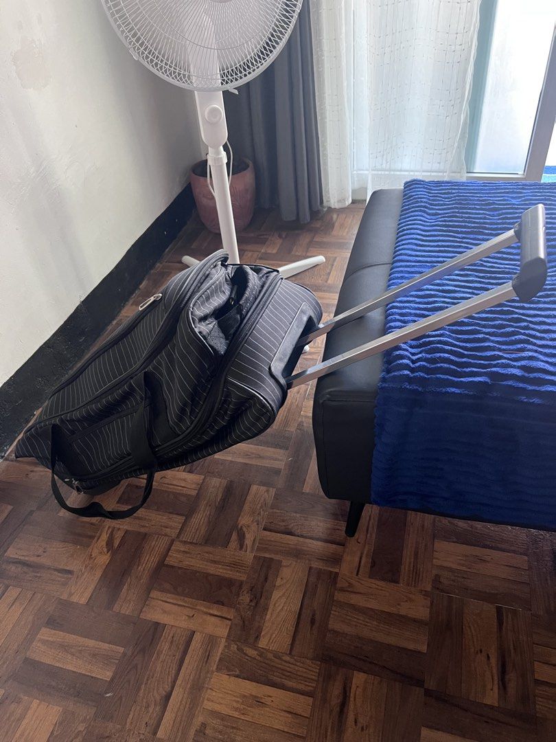 Black and white striped rolling duffel bag with handle (Category: Tote Bags) located in Manila. Submitted by nuttshellw52293 (Listing ID 1468107402, Image 3). Description: - Color & Pattern: Black with all-over white pinstripes - Mobility: Extendable metal pull handle and smooth-rolling inline wheels - Carry Options: Double grab handles and a long detachable shoulder strap - Storage: Multiple zippered compartments and a handy front pocket - Stabi