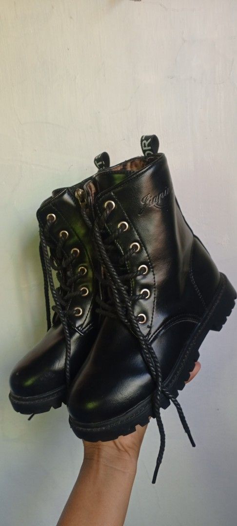 Black Combat Boots Size 33 (Category: Babies & Kids Fashion) located in Manila. Submitted by ezekislacl02490 (Listing ID 1468283208, Image 3). Description: - Style: Black combat boots with lace-up front and side zipper - Sole: Chunky lug sole for great grip and traction - Details: Heel pull tab with stylish lettering - Size: Marked as size 33 on the sole - Condition: Solid construction, very clean and well-maintained SIZE 33 FOR KIDS .