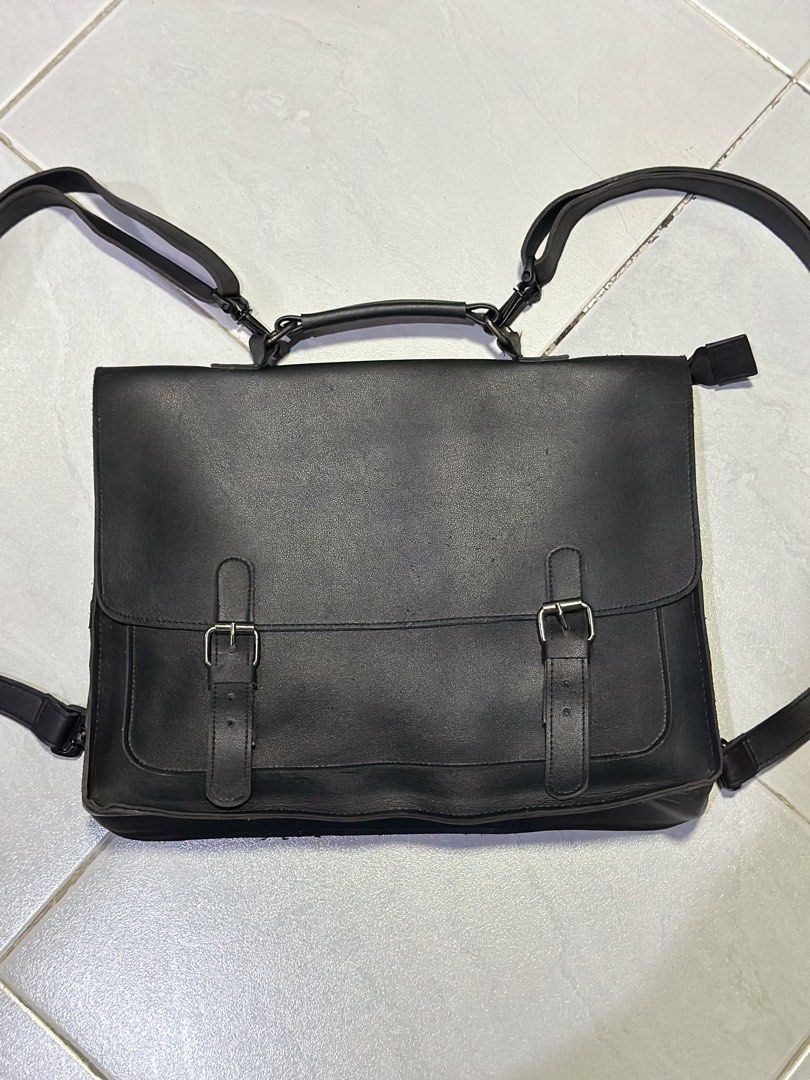 Black Leather Satchel Briefcase Convertible Backpack (Category: Sling Bags) located in Makati City. Submitted by its.ptrck (Listing ID 1468115979, Image 2). Description: - Style: (converts from messenger to backpack) - Closure: Flap with hidden magnetic snaps under decorative dual buckles - Comfort & Carry: Top handle and adjustable shoulder straps with rear D-rings - Storage: Convenient front slip pocket under the main flap - Versatility: Perfec