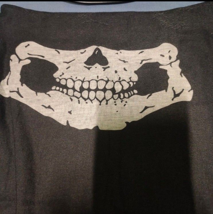 Black Skull Neck Gaiter Face Mask (Category: Scarves) located in Quezon City. Submitted by dncpreloved (Listing ID 1468158036, Image 2). Description: - Color: Black with white skull jaw and teeth print - Material: Stretchy, comfortable fabric - Design: Seamless tubular style with easy pull-on wear - Versatile: Can be worn as a face mask, headband, or neck warmer - Ideal for: Motorcycling, cycling, hiking, and other outdoor adventures.