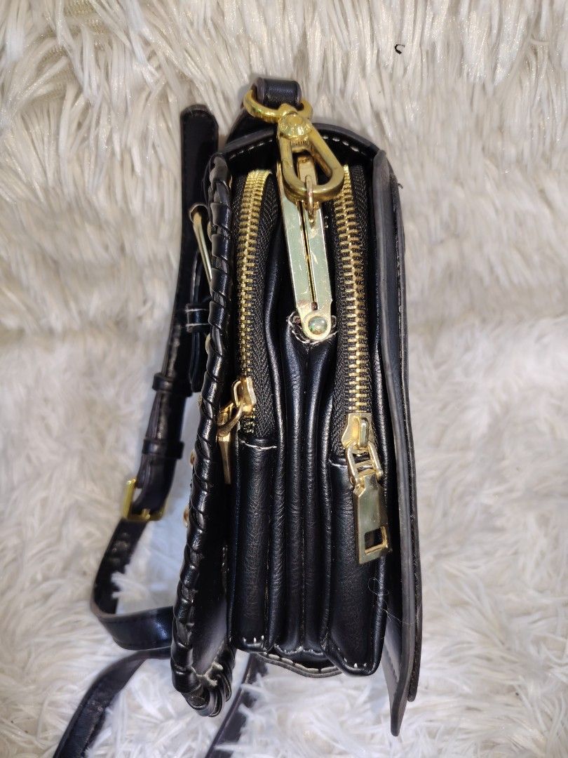 Black Studded Multi-Compartment Crossbody Bag with Gold Hardware (Category: Cross-body Bags) located in Quezon City. Submitted by zhelcloset01 (Listing ID 1468197630, Image 2). Description: Black faux leather crossbody bag with gold-tone hardware and stud details along the front flap and edges. Includes a decorative buckle strap closure and an adjustable shoulder strap. Interior features multiple zippered compartments and a kiss-lock kiss lock mi