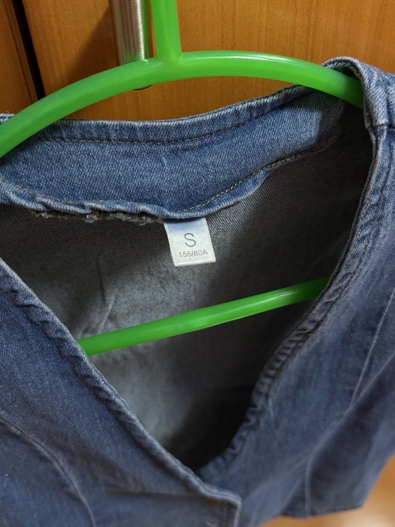 Blue denim vest crop top button up size S (Category: Sleeveless) located in Bacoor. Submitted by happyfish_028a6c (Listing ID 1468066633, Image 2). Description: Blue denim vest with a V-neck and metal buttons down the front. Cropped fit with panel stitching. Size S tag on the collar, measuring 155/80A. Material feels sturdy and classic denim blue. Great layering piece..