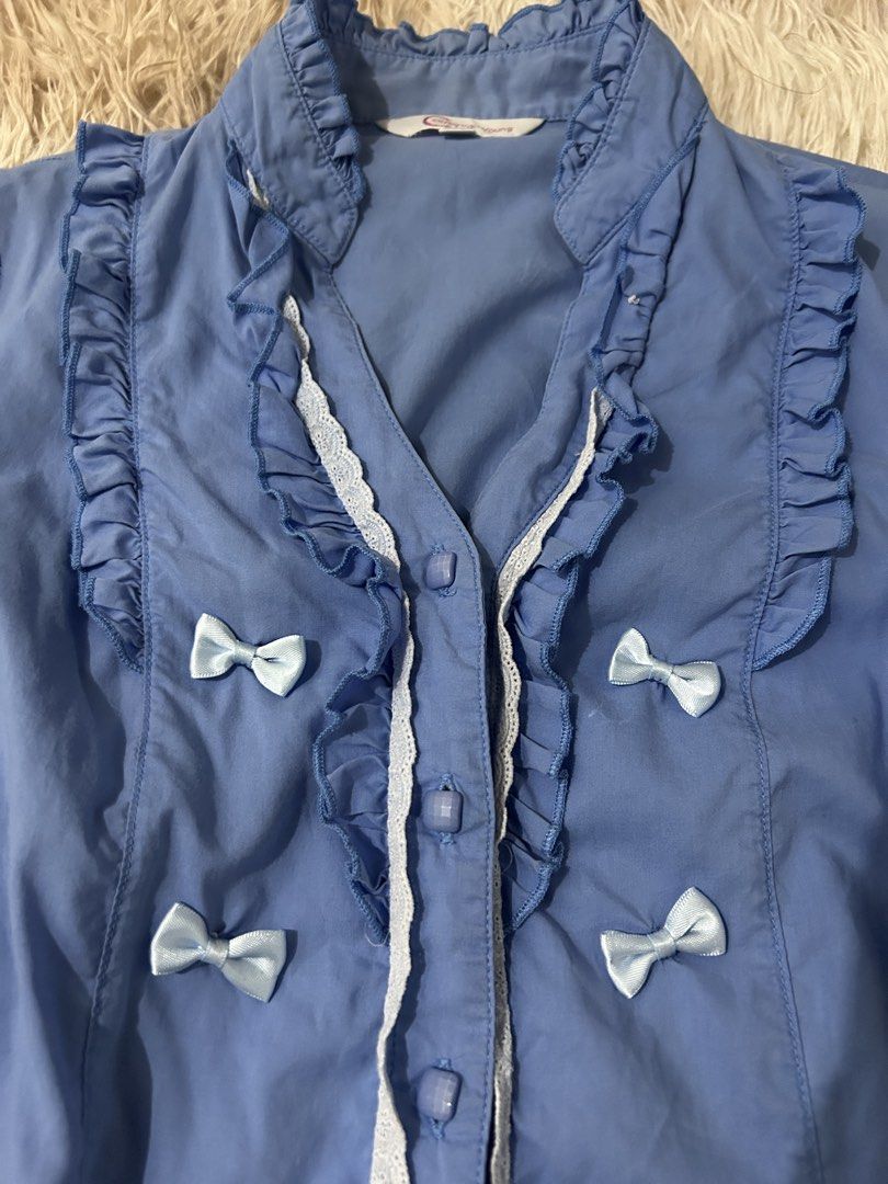 Blue Ruffled Blouse with Bows and Lace Trim (Category: Blouses) located in Mandaluyong City. Submitted by jr200407 (Listing ID 1468129371, Image 2). Description: Small Minimal flaw at the back (bleached) .