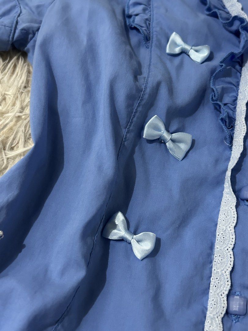 Blue Ruffled Blouse with Bows and Lace Trim (Category: Blouses) located in Mandaluyong City. Submitted by jr200407 (Listing ID 1468129371, Image 3). Description: Small Minimal flaw at the back (bleached) .