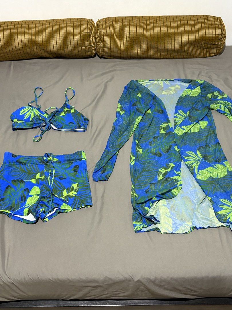 Blue Tropical Leaf Print Bikini and Cover Up Set (Category: Bikinis & Swimsuits) located in Antipolo. Submitted by alllencapinpin (Listing ID 1468256333, Image 1). Description: - 3-piece matching swim set - Includes bikini top, adjustable drawstring swim shorts, and long sleeve mesh cover-up - Eye-catching vibrant blue background with a green tropical leaf pattern - Ideal outfit for beach trips and tropical vacations - Brand new and ready to wear