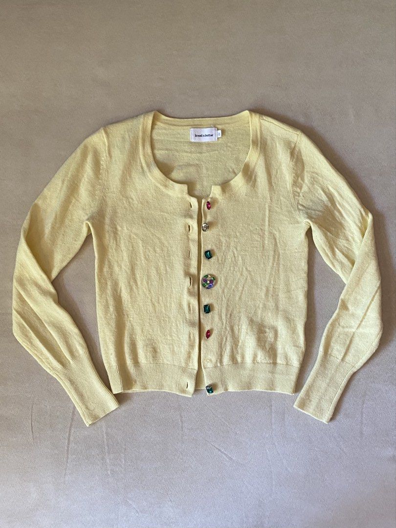 Bread n Butter Yellow Rhinestone Button Cardigan (Category: Longsleeves) located in Quezon City. Submitted by rosealison (Listing ID 1468129387, Image 1). Description: - Brand: bread n butter - Fits Extra Small or Small - Color: Butter yellow pastel - Material: Knit fabric with ribbed hem and cuffs - Details: Scoop neckline, long sleeves, and fun multicolored jewel/gemstone front buttons - Style: Great for layering.