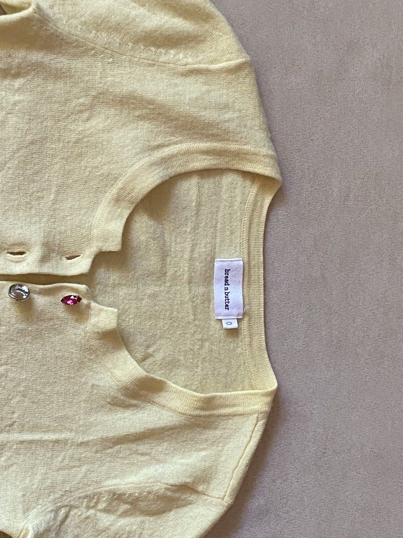 Bread n Butter Yellow Rhinestone Button Cardigan (Category: Longsleeves) located in Quezon City. Submitted by rosealison (Listing ID 1468129387, Image 3). Description: - Brand: bread n butter - Fits Extra Small or Small - Color: Butter yellow pastel - Material: Knit fabric with ribbed hem and cuffs - Details: Scoop neckline, long sleeves, and fun multicolored jewel/gemstone front buttons - Style: Great for layering.
