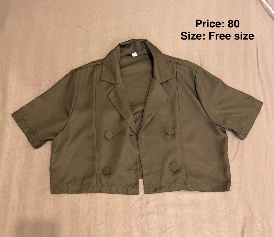 Brown Short Sleeve Crop Blazer (Category: Coats, Jackets and Outerwear) located in Makati City. Submitted by shanineee (Listing ID 1468117522, Image 1). Description: - Style: Casual short sleeve crop blazer - Color: Brown - Details: Double-breasted button front with lapel collar - Fit: Boxy fit, free size (fits most) - Versatility: Perfect to match with high-waisted pants or skirts - Condition: Clean fabric, ready to wear.