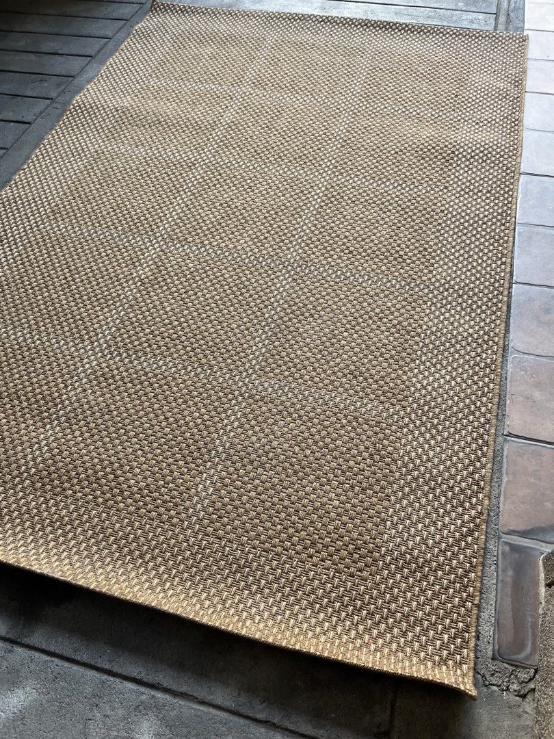 Brown Woven Area Rug (Category: Carpets, Mats & Flooring) located in Quezon. Submitted by vintage66 (Listing ID 1468097881, Image 2). Description: - Large woven area rug in a versatile brown neutral earth tone - Stylish textured basketweave pattern with neat finished borders - Flat weave construction allows for easy vacuuming and low maintenance - Perfect accent for hardwood or tile floors - Suitable for indoor spaces like living rooms and bedroo