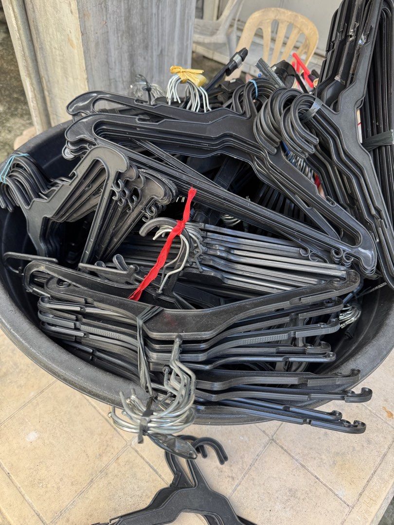 Bulk Black Plastic Clothes Hangers Lot (Category: Hooks & Hangers) located in Malabon City. Submitted by emperorseraph (Listing ID 1468103592, Image 2). Description: - Large batch of sturdy black plastic clothes hangers - Mixed styles featuring durable metal hooks and handy strap loops - Conveniently bundled in stacks inside a storage bucket and cardboard box - Ideal everyday closet organizers for home use, sorting a new wardrobe, or setting up a