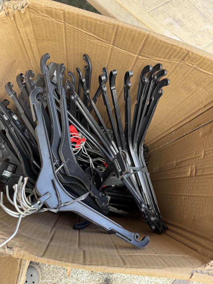 Bulk Black Plastic Clothes Hangers Lot (Category: Hooks & Hangers) located in Malabon City. Submitted by emperorseraph (Listing ID 1468103592, Image 3). Description: - Large batch of sturdy black plastic clothes hangers - Mixed styles featuring durable metal hooks and handy strap loops - Conveniently bundled in stacks inside a storage bucket and cardboard box - Ideal everyday closet organizers for home use, sorting a new wardrobe, or setting up a