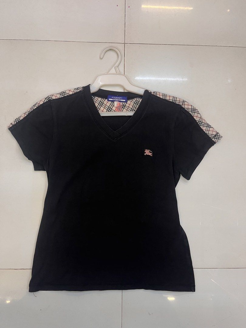 Burberry Blue Label Black V-Neck Tee with Nova Check Shoulders (Category: Shirts) located in Dagupan City. Submitted by shanadongsb (Listing ID 1468090865, Image 1). Description: - Brand: Burberry Blue Label - Color: Black with signature nova check shoulders and collar lining - Details: Embroidered pinkish equestrian knight logo on chest, blue brand label - Fit: V-neck, short sleeves - Material: Lightweight, breathable cotton - Condition: Excelle