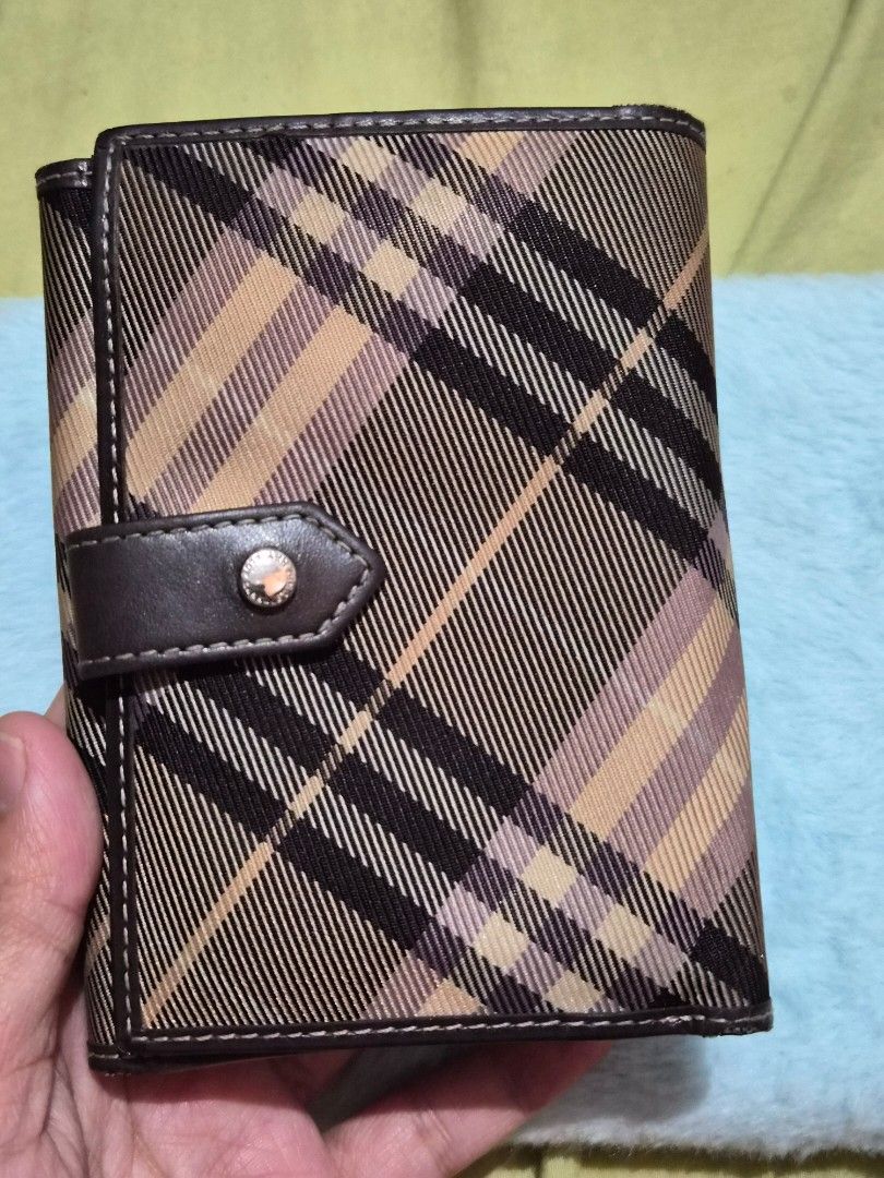Burberry Blue Label Plaid Wallet (Category: Baby Monitors) located in Mandaue City. Submitted by chuchi152615 (Listing ID 1468149488, Image 3). Description: - Authentic Burberry Blue Label tri-fold wallet - Iconic beige check pattern with premium brown leather trim - Secure snap button closure to keep your essentials safe - Features a chic engraved metal Burberry Blue Label plaque on the front - Compact design with ample card slots and cash compa