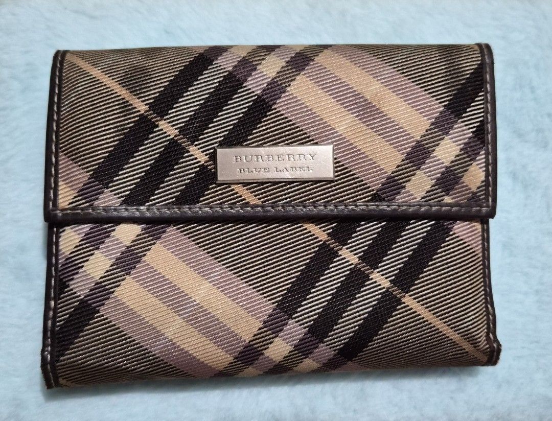 Burberry Blue Label Plaid Wallet (Category: Baby Monitors) located in Mandaue City. Submitted by chuchi152615 (Listing ID 1468149488, Image 1). Description: - Authentic Burberry Blue Label tri-fold wallet - Iconic beige check pattern with premium brown leather trim - Secure snap button closure to keep your essentials safe - Features a chic engraved metal Burberry Blue Label plaque on the front - Compact design with ample card slots and cash compa