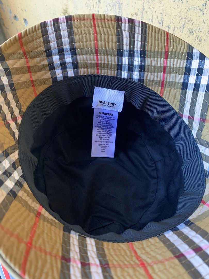 Burberry Check Bucket Hat (Category: Luxury Apparel) located in Dagupan City. Submitted by re.worth.dgpn.ph (Listing ID 1468109049, Image 3). Description: - Brand: Burberry - Pattern: Classic Archive Beige Check - Origin: Made in Italy - Material: 100% hemp outer, black inner lining - Condition: Clean fabric with tags intact inside - Fit: Standard fit - Style: Casual headwear, great for sunny days or streetwear.