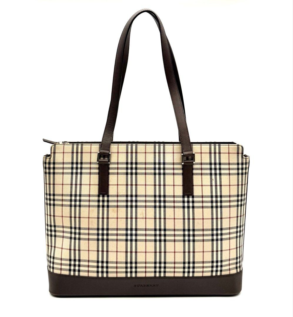 Burberry Check Tote Bag Brown (Category: Luxury Bags & Wallets) located in Quezon City. Submitted by surplus.hunter (Listing ID 1468144187, Image 2). Description: - Authentic Burberry tote bag in classic check pattern - Premium brown leather trim and sturdy handles - Secure zip top closure to keep your belongings safe - Structured rectangular base with protective metal feet - Spacious interior perfect for daily essentials - Signature branding on 