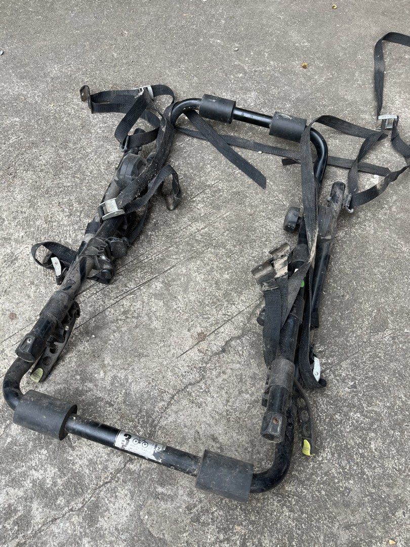 Buzz Rack trunk mount bicycle rack (Category: Bicycles) located in Manila. Submitted by cycy16_2004 (Listing ID 1468226744, Image 2). Description: - Brand/Model: Buzz Rack 3-Bike Carrier - Color/Material: Black metal frame - Capacity: Holds up to 3 bikes securely - Condition: Shows dirt and wear marks from outdoor use, but fully functional - Included: All original straps, buckles, and mounting hardware attached - Perfect for road trips and outdoo