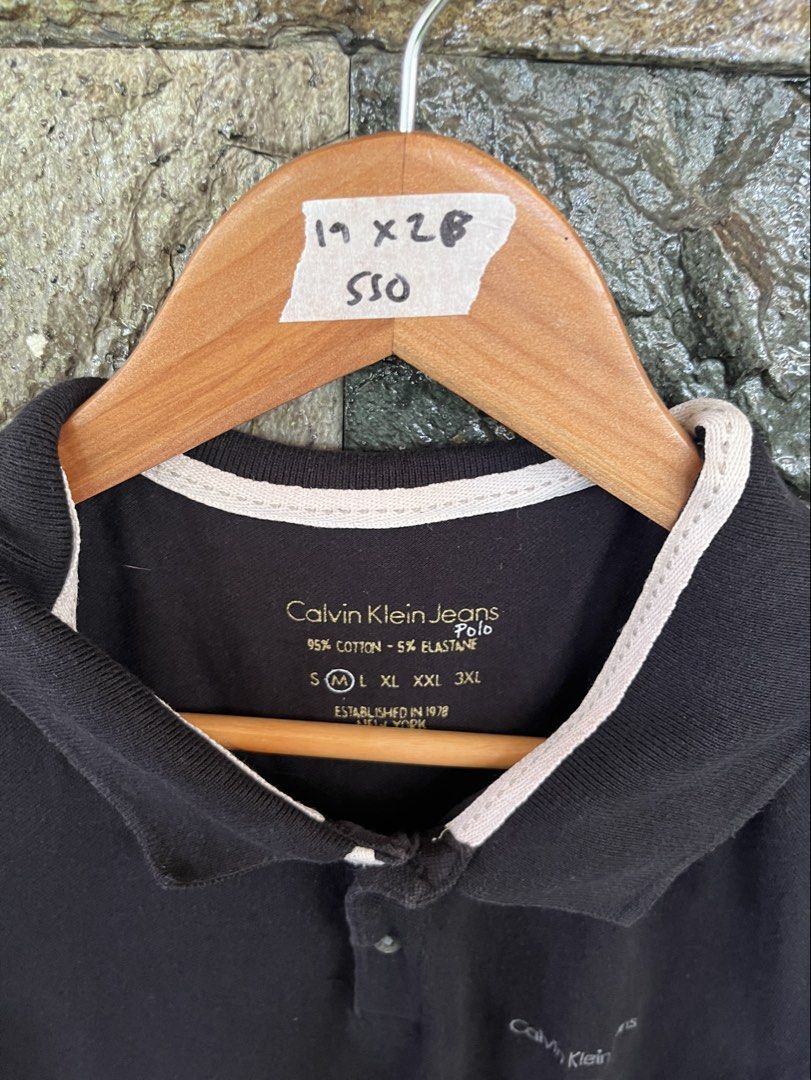 Calvin Klein Black Poloshirt (Category: Tshirts & Polo Shirts ) located in Cagayan de Oro. Submitted by curatedheirloomph_ (Listing ID 1468231864, Image 2). Description: 𝘿𝙞𝙢𝙚𝙣𝙨𝙞𝙤𝙣𝙨: 19x28 𝘽𝙚𝙨𝙩 𝙁𝙞𝙩: Medium - Large 𝘾𝙤𝙣𝙙𝙞𝙩𝙞𝙤𝙣 & 𝘾𝙤𝙡𝙤𝙧 𝙍𝙖𝙩𝙚: Excellent (9.5/10) 𝙄𝙨𝙨𝙪𝙚: Minimal lints 𝘼𝙪𝙩𝙝𝙚𝙣𝙩𝙞𝙘𝙞𝙩𝙮 𝘿𝙚𝙘𝙡𝙖𝙧𝙖𝙩𝙞𝙤𝙣: Authentic.