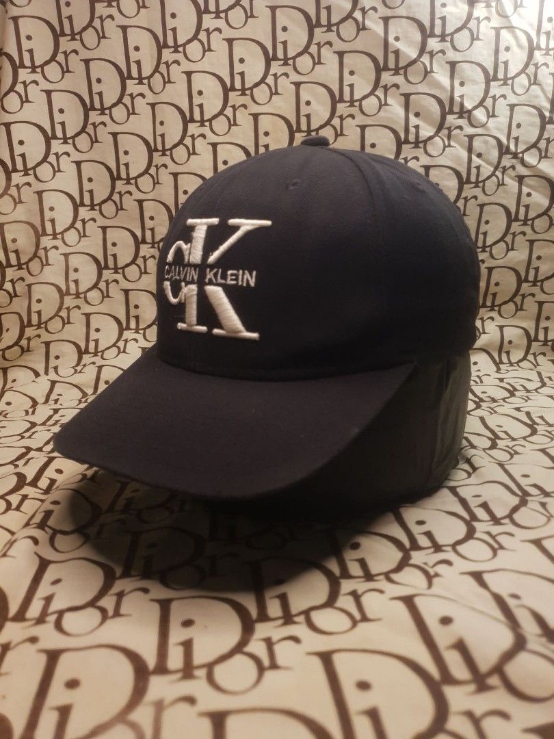 CALVIN KLEIN BLACK SNAPBACK CAP (Category: Caps & Hats) located in San Fernando. Submitted by _jaximus (Listing ID 1468217160, Image 2). Description: - Brand: Calvin Klein - Color: Classic black with white embroidered CK logo - Closure: Adjustable snapback for a custom fit - Design: Structured crown and curved brim - Style: Versatile and clean, perfect for any casual look - Size: Standard adult sizing.