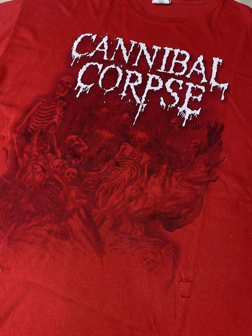 Cannibal Corpse Band Tee Red 2XL Gildan (Category: Tshirts & Polo Shirts ) located in Muntinlupa City. Submitted by ajdomingo504210 (Listing ID 1468067100, Image 2). Description: - Band: Cannibal Corpse - Color: Red - Size: 2XL (Gildan Heavy Cotton tag) - Origin: Made in Haiti - Design: Large white logo and red graphic print on front with official copyright text - Flaws: Noticeable cracking on the printed lettering and a couple of small holes nea