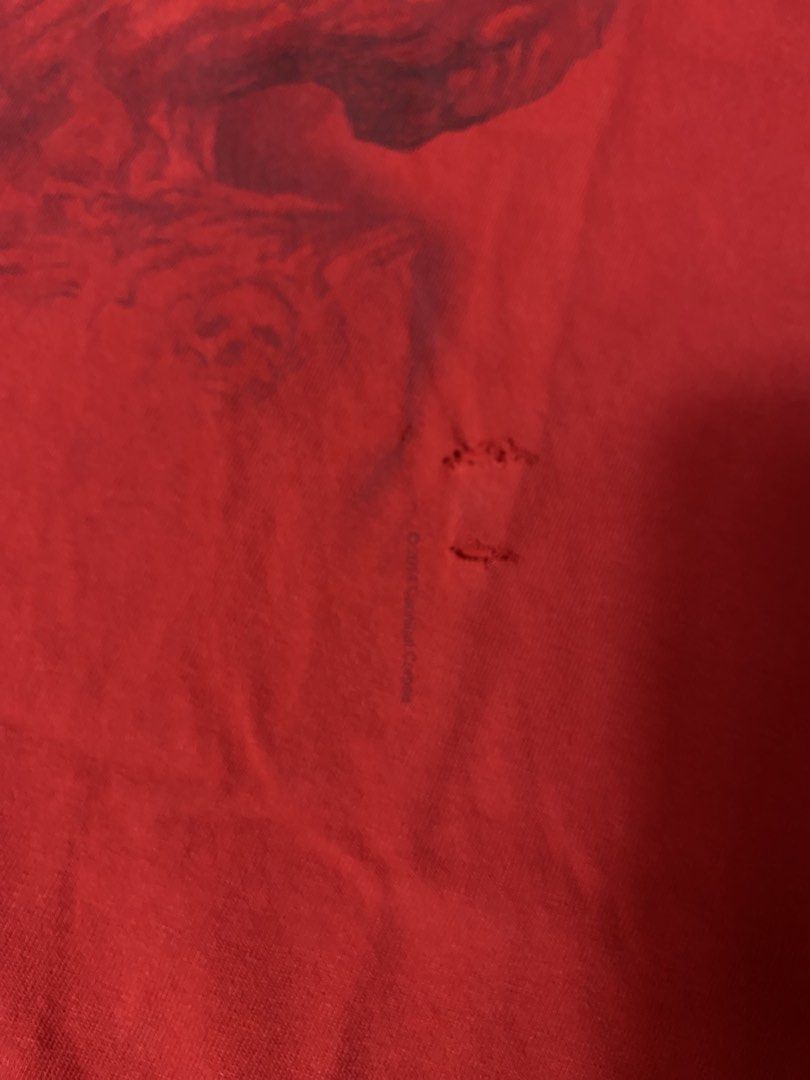 Cannibal Corpse Band Tee Red 2XL Gildan (Category: Tshirts & Polo Shirts ) located in Muntinlupa City. Submitted by ajdomingo504210 (Listing ID 1468067100, Image 3). Description: - Band: Cannibal Corpse - Color: Red - Size: 2XL (Gildan Heavy Cotton tag) - Origin: Made in Haiti - Design: Large white logo and red graphic print on front with official copyright text - Flaws: Noticeable cracking on the printed lettering and a couple of small holes nea