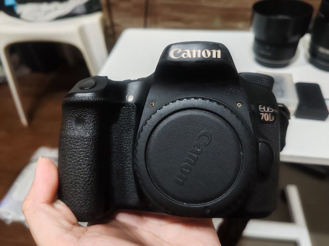 Canon EOS 70D DSLR Camera Bundle with Lenses and Accessories (Category: Cameras) located in Manila. Submitted by sevvvvvv (Listing ID 1468140469, Image 3). Description: - Canon EOS 70D camera body (cosmetic wear on edges and minor rust on hot shoe) - Two included lenses with lens hoods - Battery charger, power cable, and spare batteries in protective cases - SanDisk 32GB SD card - Original Canon neck strap - All items tested and in 100% working c