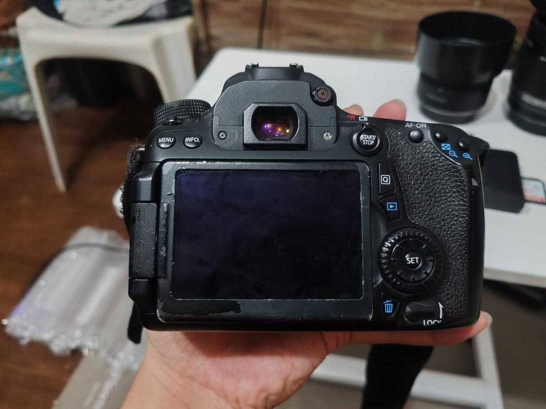 Canon EOS 70D DSLR Camera Bundle with Lenses and Accessories (Category: Cameras) located in Manila. Submitted by sevvvvvv (Listing ID 1468140469, Image 2). Description: - Canon EOS 70D camera body (cosmetic wear on edges and minor rust on hot shoe) - Two included lenses with lens hoods - Battery charger, power cable, and spare batteries in protective cases - SanDisk 32GB SD card - Original Canon neck strap - All items tested and in 100% working c