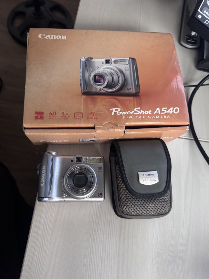 Canon PowerShot A540 Digital Camera with Box and Case (Category: Cameras) located in Manila. Submitted by cruzgiusep32732 (Listing ID 1468122650, Image 2). Description: Canon Powershot A540 - Body condition: 9.8/10 Includes: 💼 - unit - battery (AA) - 2gb SD Card - strap - pouch - original box Specs: ✍️ - Color: silver - 6mp - Image sensor: 1/2.5-inch CCD ￼ - Lens: 5.8 mm (W) – 23.2 mm (T) (35 mm-film equivalent: 35-140 mm) ￼ - Maximum aperture: 