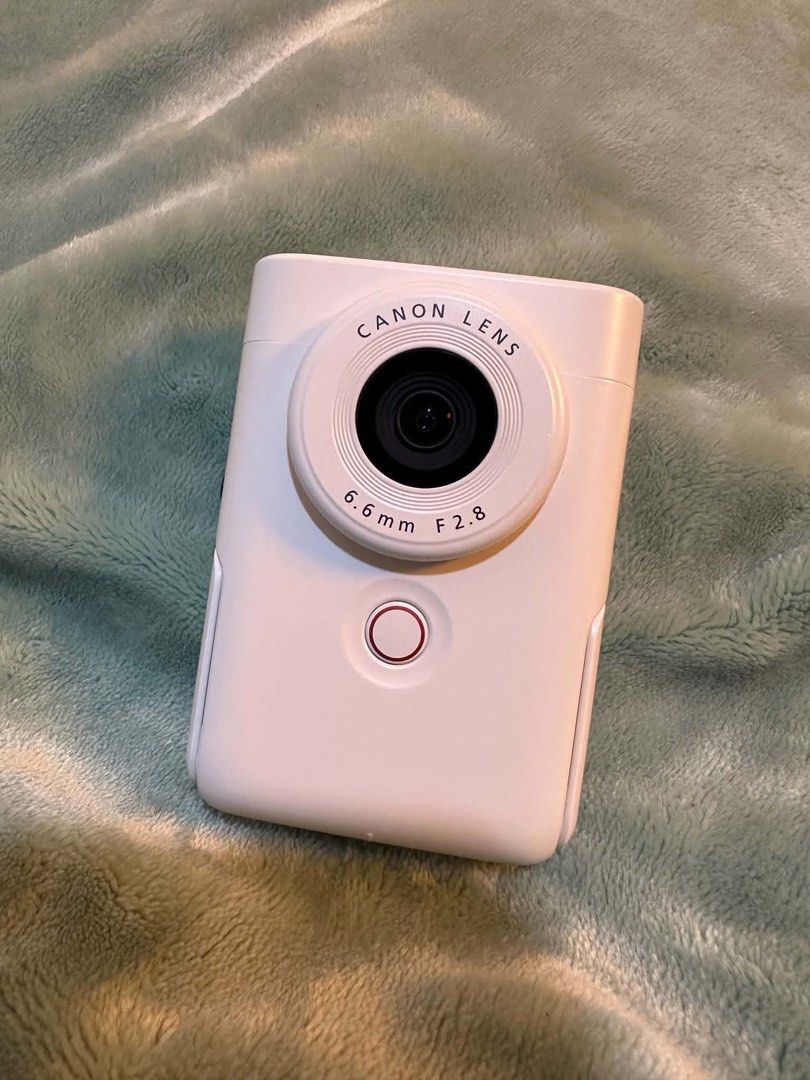 Canon PowerShot V10 Vlogging Camera White (Category: Cameras) located in Hagunoy. Submitted by nompnomp (Listing ID 1468242402, Image 2). Description: - Model: Compact vlogging camera in a stylish white finish - Lens: Canon 6.6mm F2.8 lens for great quality shots - Display & Design: Flip-up screen and convenient built-in stand - Usability: Simple button layout on the back for hassle-free operation - Inclusions: Comes with the original box - Still