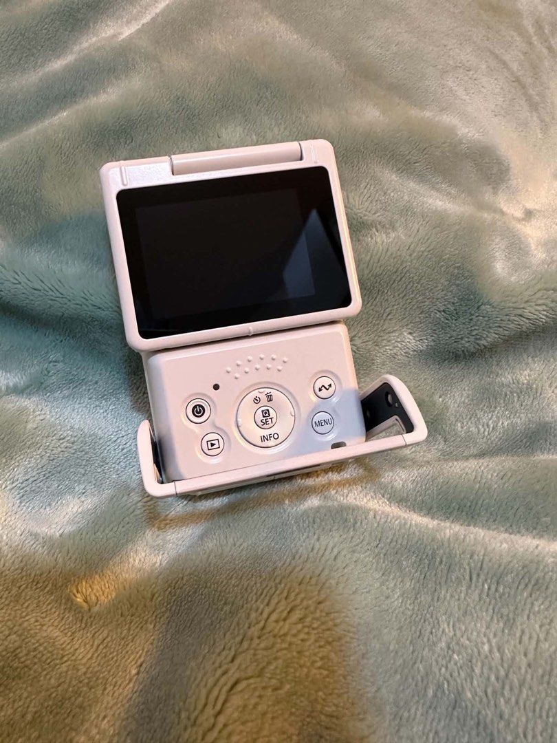 Canon PowerShot V10 Vlogging Camera White (Category: Cameras) located in Hagunoy. Submitted by nompnomp (Listing ID 1468242402, Image 3). Description: - Model: Compact vlogging camera in a stylish white finish - Lens: Canon 6.6mm F2.8 lens for great quality shots - Display & Design: Flip-up screen and convenient built-in stand - Usability: Simple button layout on the back for hassle-free operation - Inclusions: Comes with the original box - Still