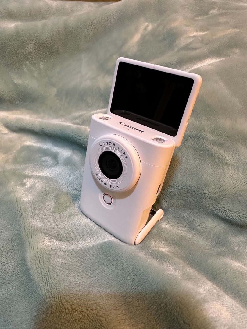 Canon PowerShot V10 Vlogging Camera White (Category: Cameras) located in Hagunoy. Submitted by nompnomp (Listing ID 1468242402, Image 1). Description: - Model: Compact vlogging camera in a stylish white finish - Lens: Canon 6.6mm F2.8 lens for great quality shots - Display & Design: Flip-up screen and convenient built-in stand - Usability: Simple button layout on the back for hassle-free operation - Inclusions: Comes with the original box - Still